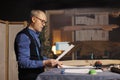 Dressmaker looking over sketch drawings