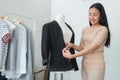 Dressmaker measuring a women suit and dress