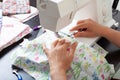 Dressmaker at work, building patterns, hands, modeling, measuring, sewing machine