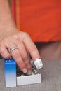 Dressmakers hands thimble finger reaching into box of pins Royalty Free Stock Photo