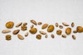 Dried almonds, pistachios, nuts and dried fruits are laid out on a light gray background, healthy food for raw foodists Royalty Free Stock Photo