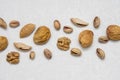 Dried almonds, pistachios, nuts and dried fruits are laid out on a light gray background, healthy food for raw foodists Royalty Free Stock Photo