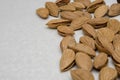 Dried almonds spilled out on a gray background. healthy food for raw foodists and vegetarians. Royalty Free Stock Photo