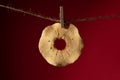 Dried apple slice on a rope on a clothespin. Royalty Free Stock Photo