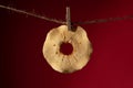 Dried apple slice on a rope on a clothespin.