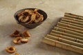 Dried Apple slices in a ceramic Cup and a bamboo Mat Royalty Free Stock Photo