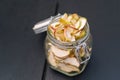 Homemade organic dried apple chips in glass bottle with fresh apple Royalty Free Stock Photo