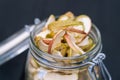 Homemade organic dried apple chips in glass bottle with fresh apple Royalty Free Stock Photo