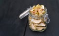 Homemade organic dried apple chips in glass bottle with fresh apple Royalty Free Stock Photo