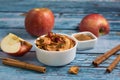 Dried apples in a white bowl with dried cinnamon bark strips