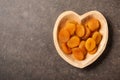 Dried apricot fruit in heart shaped bowl Royalty Free Stock Photo