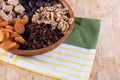 Dried apricot, nuts, faygi, dates and raisins in a wooden cup on a tablecloth Royalty Free Stock Photo