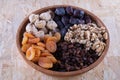 Dried apricot, nuts and raisins in a wooden cup Royalty Free Stock Photo