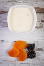 Dried apricot, plum and yoghurt in bowl, increase metabolism