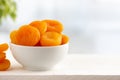 Dried apricots in a bowl on white wooden table Royalty Free Stock Photo