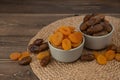 Dried apricots and dates fruits on dark wood background with copy space. Royalty Free Stock Photo