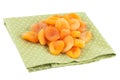 Dried Apricots on a green napkin isolated on white