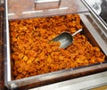 Dried apricots with a large metal spoon / scoop ready to be sold unpackaged to the environmentally conscious customers in a zero