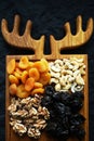 Dried fruits and nuts on a wooden board on a dark background Royalty Free Stock Photo