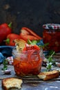 Dried baked Bulgarian red pepper, paprika with herbs rosemary, thyme, marjoram, garlic with olive oil in a glass jar Royalty Free Stock Photo