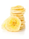 Dried banana chips snack stacked over white