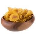 Dried banana chips in wooden bowl. Yellow deep fried slices of b Royalty Free Stock Photo