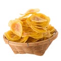 Dried banana chips in wooden bowl. Yellow deep fried slices of b Royalty Free Stock Photo