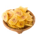 Dried banana chips in wooden bowl. Yellow deep fried slices of b Royalty Free Stock Photo