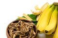 Dried bananas in the bowl and fresh bananas isolated on white background. Sticks of dehydrated banana pulp Royalty Free Stock Photo