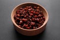 Dried barberries in wooden bowl on grey background Royalty Free Stock Photo