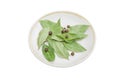 Dried bay leaves and allspice on a saucer Royalty Free Stock Photo