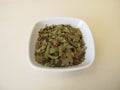 Dried bearberry leaves and fruits on a wooden board