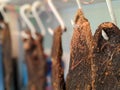 A row of dried beef meat jerky biltong hanging on hooks