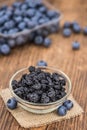 Portion of Dried Blueberries on wooden background, selective focus