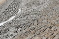 Dried bottom of KlÃÂ¶ntalersee lake tiled with stones with patches of snow used as background