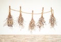 Dried bouquet flowers on the wall. Vintage house decoration idea. Vintage style filter