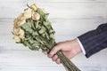 Dried bouquet of white roses in the hand