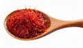 Dried bright red saffron in a wooden spoon isolated on white background Royalty Free Stock Photo