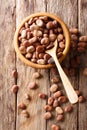 Dried broad beans close-up in a wooden bowl. Vertical top view Royalty Free Stock Photo