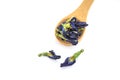 Dried butterfly pea flowers in a wooden spoon on white background. Blue flower for tea Royalty Free Stock Photo