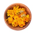 Dried calendula flowers in wooden bowl, isolated on white background. Petals of Calendula officinalis. Medicinal herbs Royalty Free Stock Photo