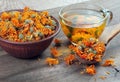 Dried calendula flowers in a wooden spoon. calendula tea. alternative medicine Royalty Free Stock Photo