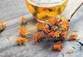 Dried calendula flowers in a wooden spoon. calendula tea. alternative medicine Royalty Free Stock Photo