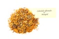 Dried calendula and a tag that says Calendula officinalis or Marigold Royalty Free Stock Photo