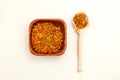 Dried calendula in a wooden bowl and wooden spoon on a light background. Apothecary herbs Royalty Free Stock Photo