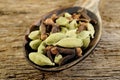 Dried cardamom with dried cloves in old wooden