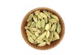 Dried cardamom seeds in a wooden bowl