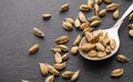 Dried cardamoms in rustic silver spoon on slate background