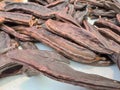 Dried carob pods close-up display Royalty Free Stock Photo