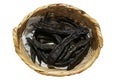 Dried carob pods in wicker basket Royalty Free Stock Photo